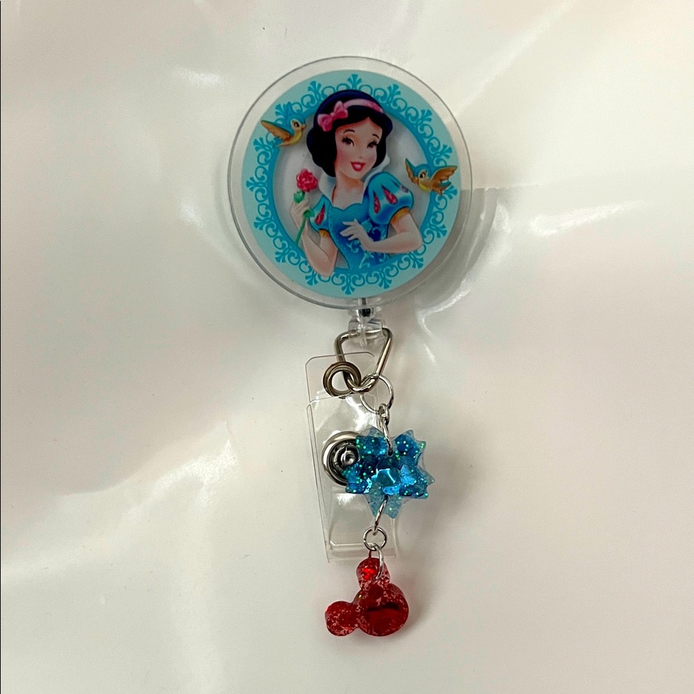 Snow White Badge Reel with Blue and Red Charms